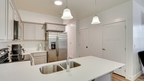 A modern kitchen with white cabinetry, stainless steel appliances, and pendant lighting. - 15 Mi to Sundance: Pet-Friendly Condo in Vineyard (Vineyard)