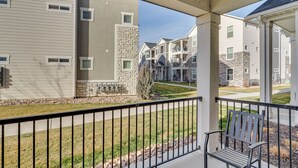 A residential building with a balcony, stone accents, and a view of neighboring houses. - 15 Mi to Sundance: Pet-Friendly Condo in Vineyard (Vineyard)