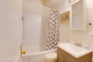 A bathroom with a bathtub, toilet, and sink. - Quiet St Louis Apt: 3 Mi to Carondelet Park (St. Louis)
