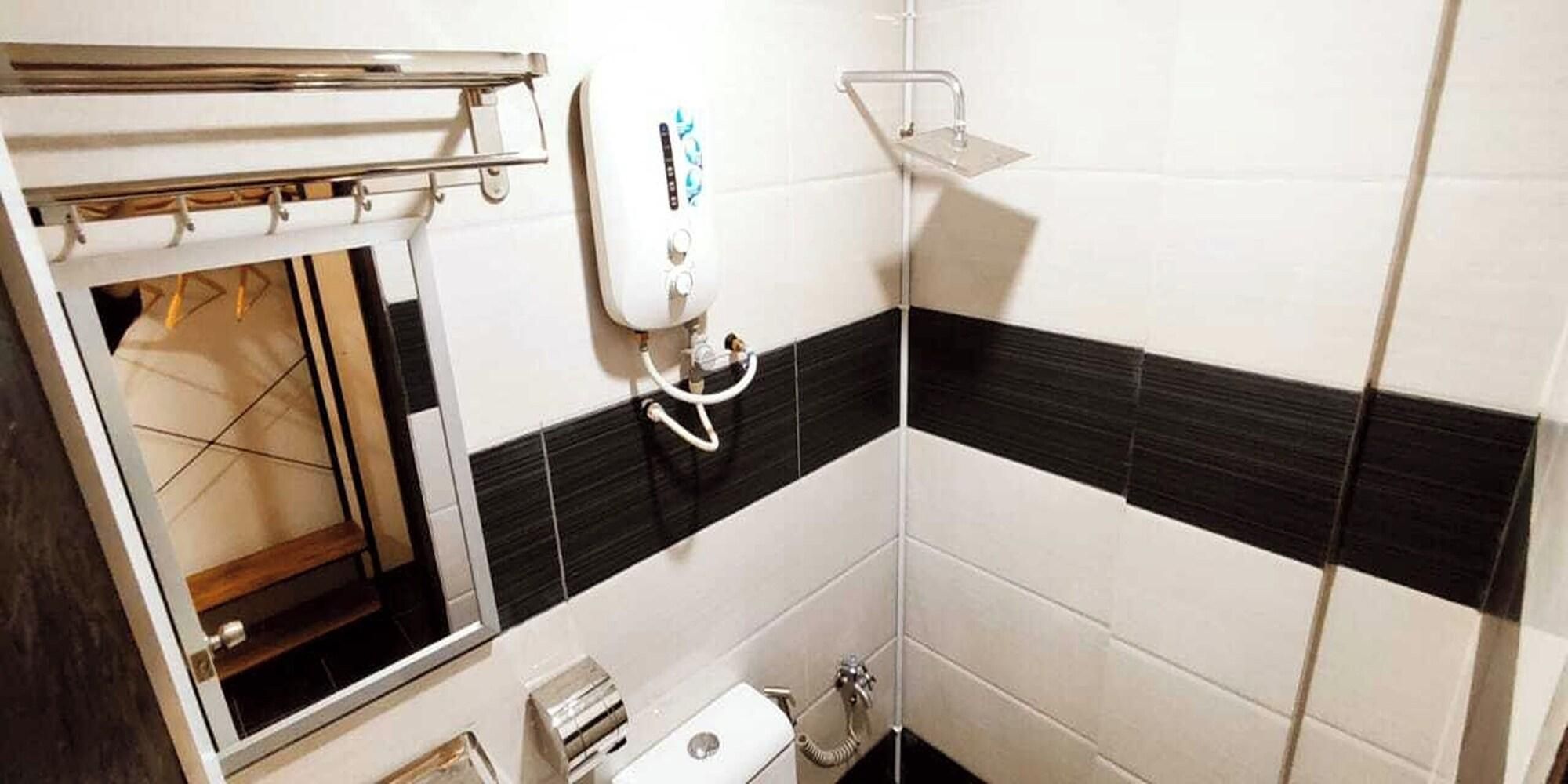A bathroom with a toilet, sink, and shower.