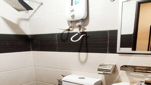 A compact bathroom with a toilet, sink, and a towel rack. - ABA Hotel Sarawak By Zuzu (Kota Samarahan)