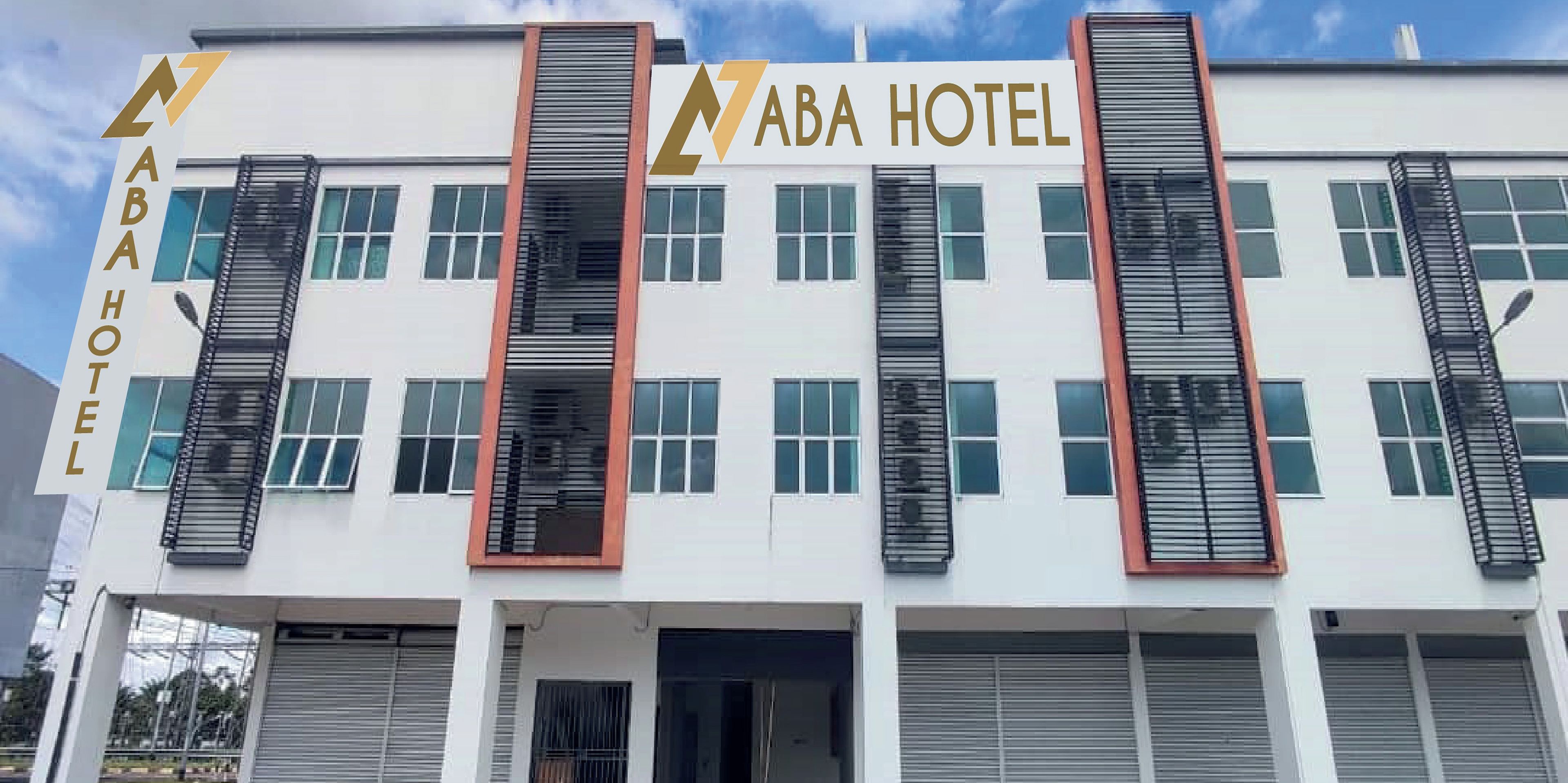 A modern building with the sign "ABA HOTEL" prominently displayed.
