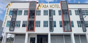 A modern building with the sign "ABA HOTEL" prominently displayed.