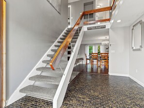A staircase with wooden handrails and a sign that reads "Family is life's greatest blessing." - Spacious 5-bedroom house in charming New London, CT with WiFi & a Game Room. (New London)