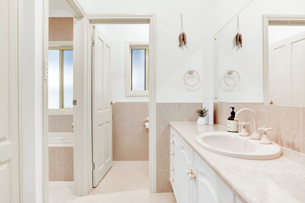 A modern bathroom with a large sink, vanity, and two mirrors. - The Stately Way, Wallaroo (Wallaroo)