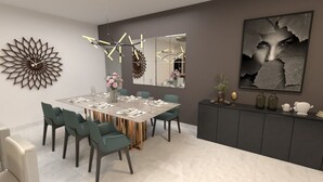 A modern dining area with a rectangular table, teal chairs, and a decorative wall piece. - Milas House (La Romana)