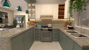 A modern kitchen with a central island, built-in appliances, and pendant lighting. - Milas House (La Romana)