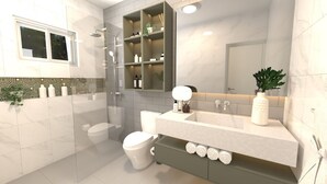 A modern bathroom with a glass shower enclosure, a white toilet, a vanity with a mirror, and a shelf with toiletries. - Milas House (La Romana)