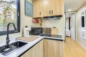 Fridge, microwave, coffee/tea maker, cookware/dishes/utensils