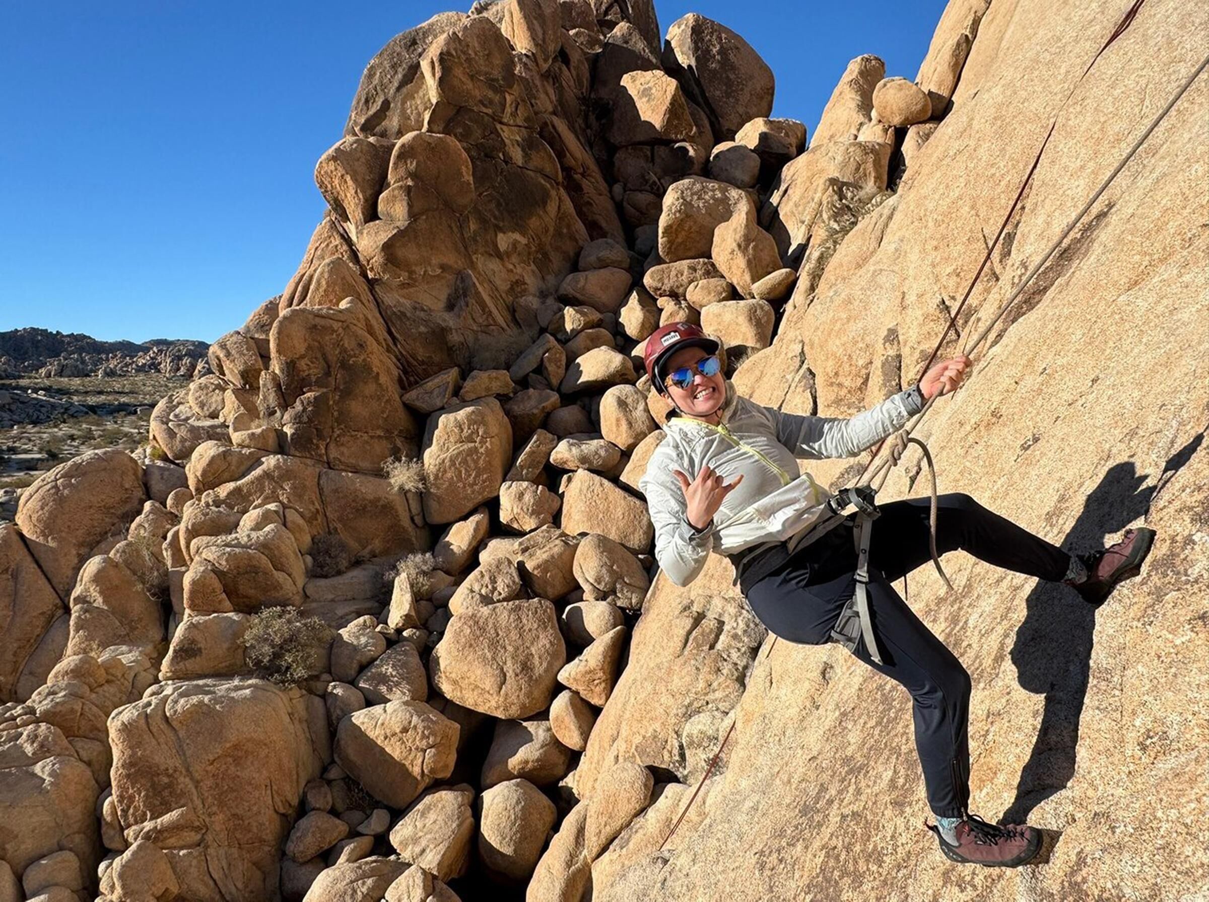 A person climbing a rocky cliff.