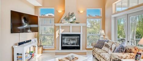 A spacious living room with a fireplace, a television, and a comfortable seating area.