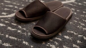 A pair of brown mesh slippers on a patterned carpet. - Jr East Hotel Mets Musashisakai (Musashino)