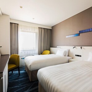 A hotel room with two beds, a desk, a chair, and a window with curtains. - Jr East Hotel Mets Musashisakai (Musashino)