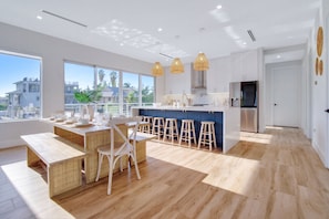 Dining area + kitchen. - Keys Casa: Elegant Waterfront Retreat, Sleeps 16, Elevator, Private Dock, Putt-Putt (Key Largo)