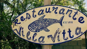 A restaurant sign with a shark design, established in 1978.