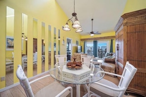 Relax in this airy space with a glass-top dining table and comfortable sofa.