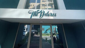 A building with a sign reading "The Delores" at the entrance.