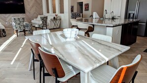 A modern kitchen with a marble countertop, a built-in island, and dark wooden cabinets. - Views, Views, Views.Beautiful 2800 sqft 30 mins to Tahoe large backyard. (Reno)