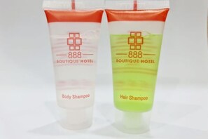 Two bottles of shampoo from Boutique Hotel, one labeled body and the other hair.