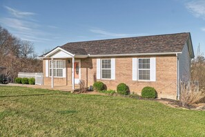 A single-story brick house with a gabled roof, white shutters, and a front porch. - Rainbow Ranch: Family Friendly 4 Bedroom in Lovely Williamstown, 5 min to ARK! (Williamstown)