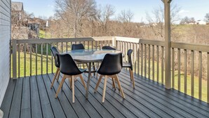 A wooden deck with a glass-top table and four black chairs. - Rainbow Ranch: Family Friendly 4 Bedroom in Lovely Williamstown, 5 min to ARK! (Williamstown)