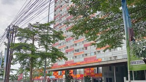 A multi-story building with a sign reading "TOWER MAHAKAM".