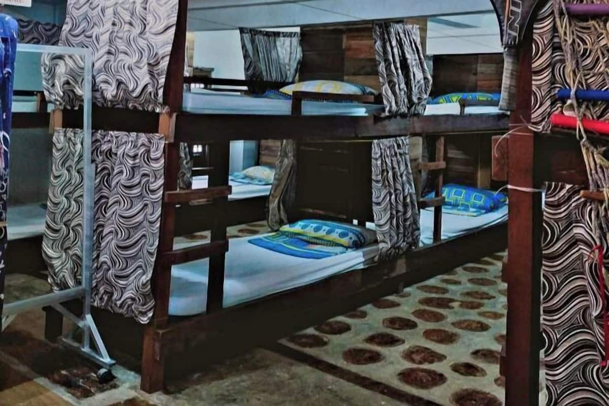 A bunk bed room with patterned curtains and a patterned floor.