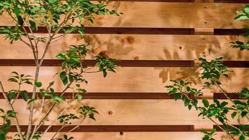 A wooden wall with horizontal planks and visible screws.
