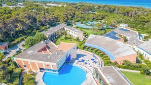An aerial view of a resort with a central swimming pool, multiple buildings, and surrounding greenery. - Le Onde Apartment 2 with Pool n.115/a, Otranto, Italy (Otranto)