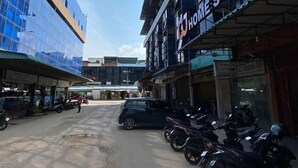 A street view with a building labeled "HOMESTAY" and several parked motorcycles. - CJ HOMESTAY (Batam)
