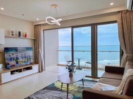 Deluxe Apartment, 3 Bedrooms, Sea View | Living area | 70-cm flat-screen TV with digital channels, foosball, table tennis