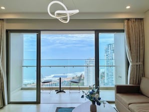 Deluxe Apartment, 3 Bedrooms, Sea View | Living area | 70-cm flat-screen TV with digital channels, foosball, table tennis