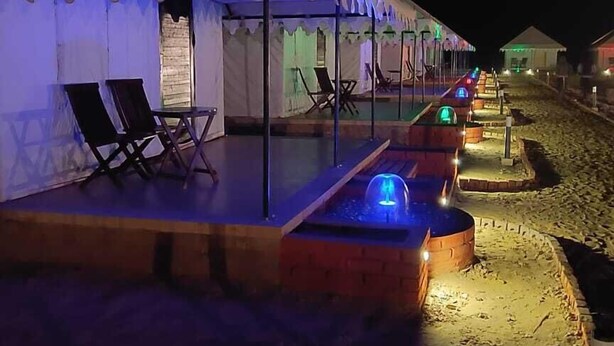 A tented area with lounge chairs and a pool, suggesting a resort setting. - DESERT LEELA RESORT (Jaisalmer)