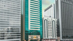 A modern high-rise building with a prominent Jannah Executive Hotel sign. - Jannah Executive Hotel Apartments (Abu Dhabi)