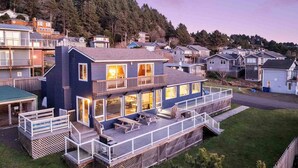 Une maison à deux étages avec un balcon, une terrasse et un garage.