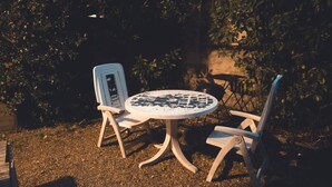 Un tavolo rotondo con quattro sedie in un giardino.