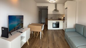 A compact living space with a kitchenette, a dining area, and a seating area.