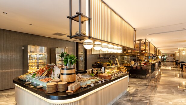 A buffet area with a variety of food items and a modern interior design. - Nanjing Yangzi River Conference Center Longshan Lake Hotel (Nanjing)
