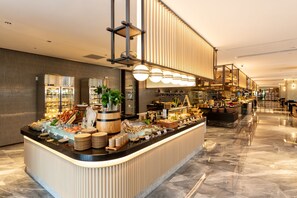 A buffet area with a variety of food items and a modern interior design. - Nanjing Yangzi River Conference Center Longshan Lake Hotel (Nanjing)