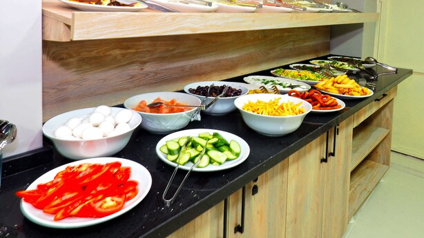 A buffet with various food items and utensils. - Diamond Hotel Old City (Istanbul)