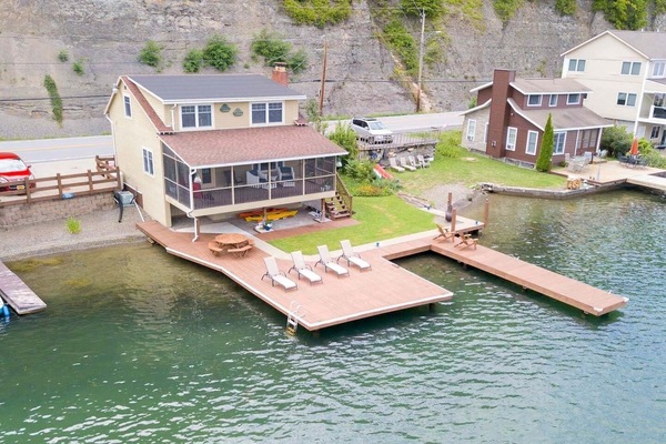 Nestled at the edge of a serene lake, this charming dock features a row of inviting, comfortable chairs, perfect for relaxing and enjoying the peaceful surroundings. The chairs, crafted from weather-resistant materials, are designed for comfort with