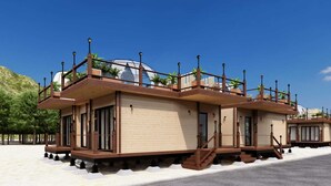 A building with a flat roof, multiple windows, and a balcony. - Regenta Evolife Dome City Mahakumbh Prayagraj (Karchana)