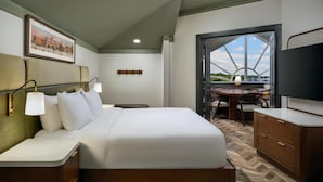 A hotel room with a bed, bedside tables, a desk, and a television. - Tryon Riverfront Inn New Bern, Tapestry (New Bern)