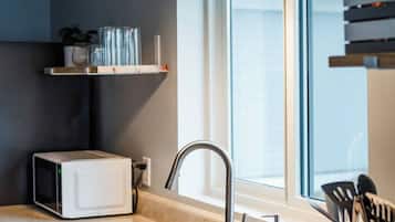 Fridge, coffee/tea maker, high chair, cookware/dishes/utensils