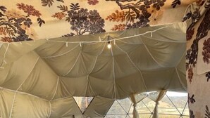 A cozy tent with two beds, a small table, and a rug. - Eagles dôme (Boutferda)