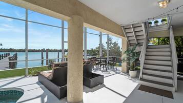 A spacious indoor area with a pool, large windows, and a staircase.