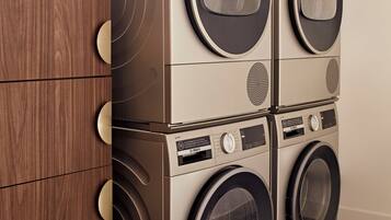 A four-door wall-mounted washer and dryer unit with a control panel and a digital display.