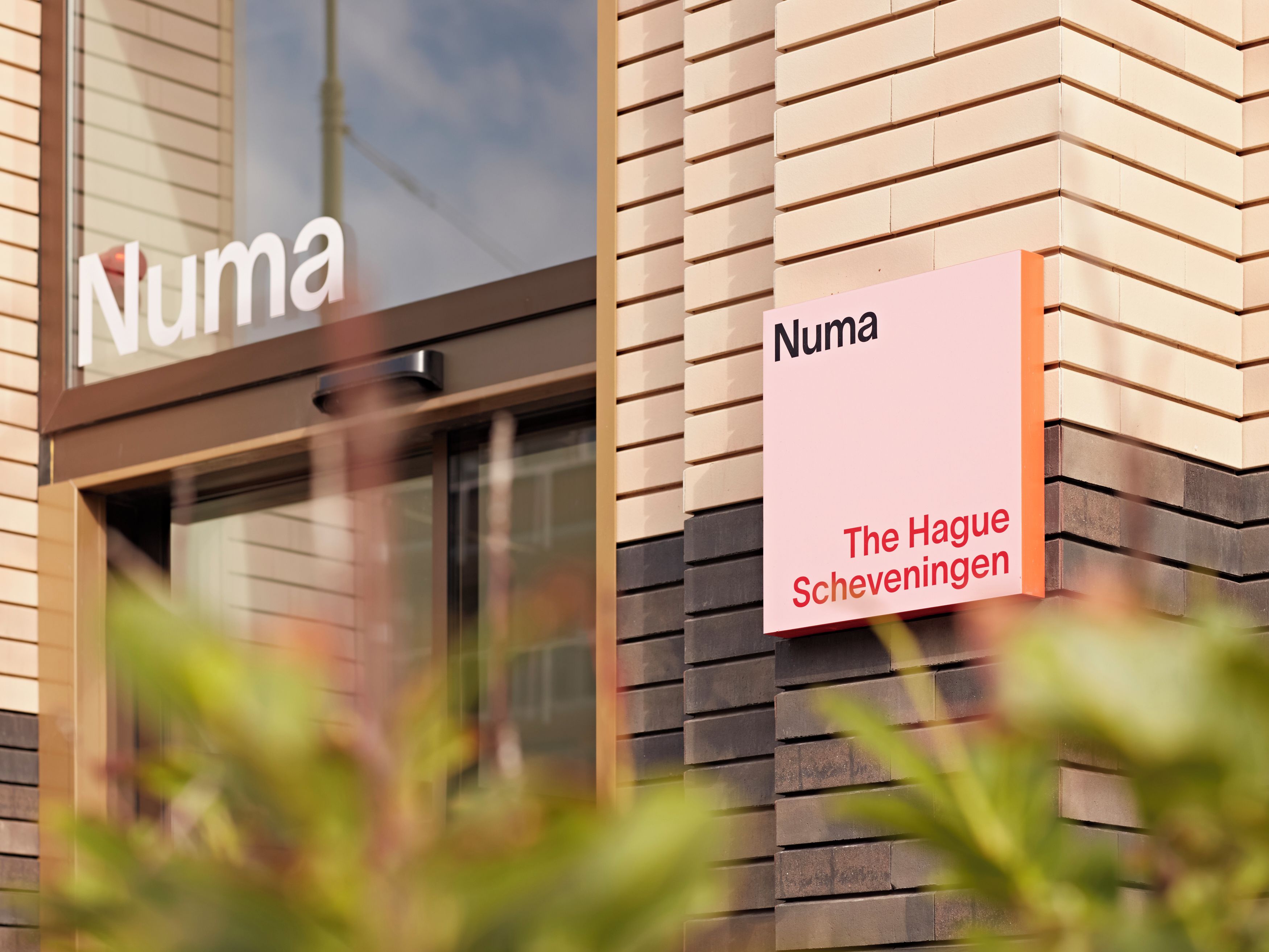 A building facade with a sign reading 'Numa The Hague Scheveningen'.