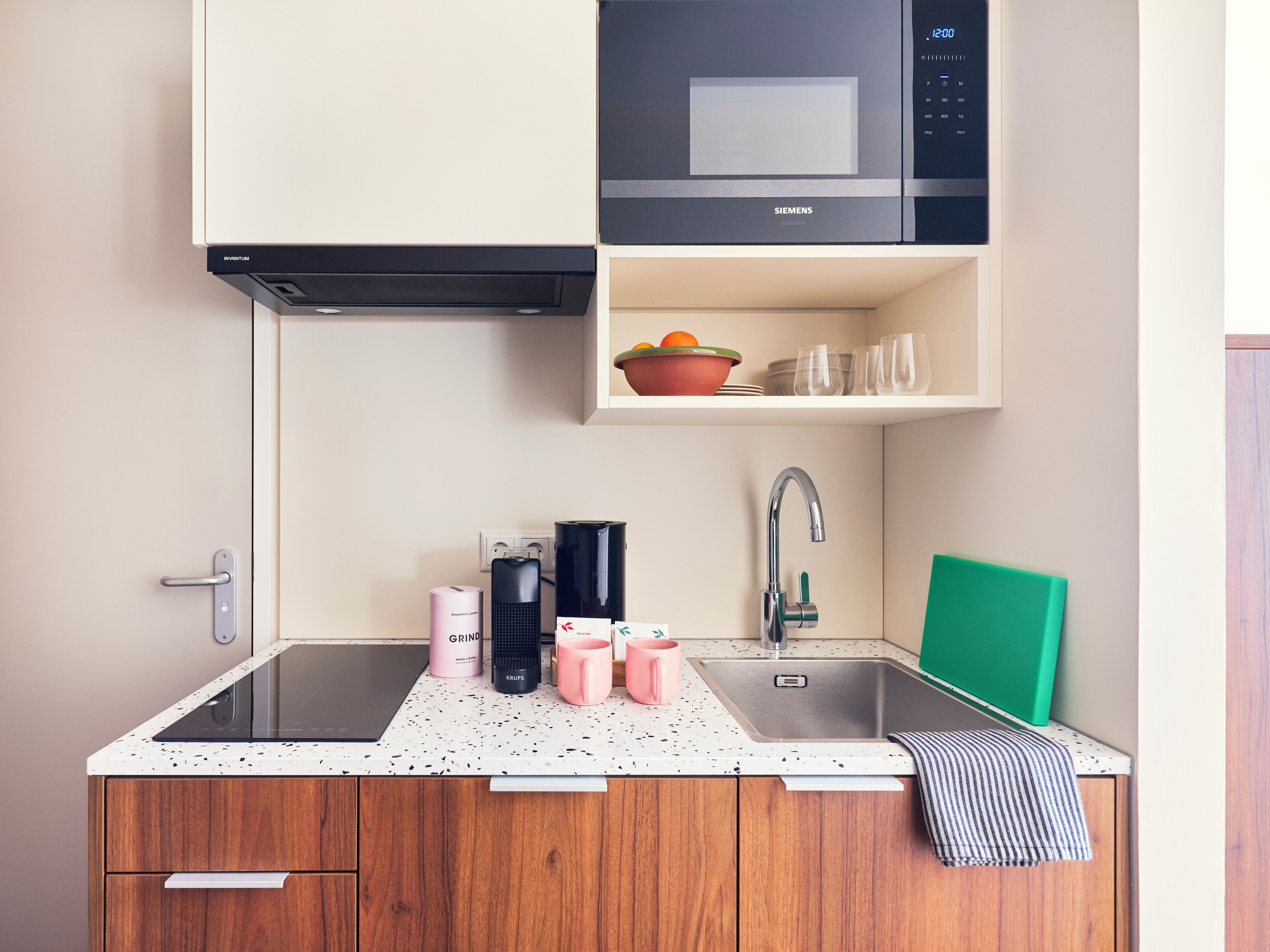 A kitchen with a microwave, sink, and countertop.