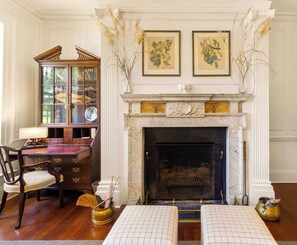 A room with a fireplace, a wooden desk with drawers, a chair, and a bookshelf. - Historic Riverfront Estate 700 Acres, Pool, Dock & Lakes (Saluda)